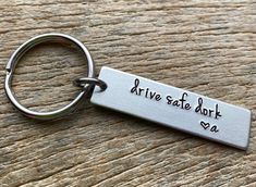 a metal keychain that says drive safe work