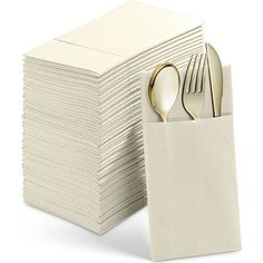 a stack of white napkins with silverware in it