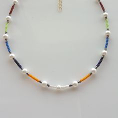 Add a pop of color to your summer wardrobe with this stunning and vibrant colorful seed bead boho necklace. Handcrafted with care, this pearl beaded necklace is the perfect accessory for a casual day at the beach or a fun night out. The rainbow beads add a playful touch, making it a versatile piece for any occasion. This beaded choker necklace also makes a thoughtful gift for her or him, adding a touch of bohemian flair to their jewelry collection. Make a statement with this unique and stylish b Bohemian Beaded Necklaces With Spacer Beads For Vacation, Bohemian Beaded Necklace For Vacation, Summer Beach Beaded Necklaces With Spacer Beads, Summer Beach Beaded Necklace With Spacer Beads, Colorful Beaded Necklace For Vacation, Heishi Beads Beaded Necklace For Summer, Colorful Round Beaded Necklaces For Vacation, Colorful Round Beads Necklace For Vacation, Multicolor Heishi Beads For Summer