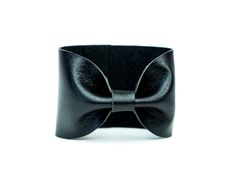 "Noir Black Bow Tie Vegan Leather Wide Cuff Bracelet by ForgottenCotton Because we know that Bow Ties are cool. Our noir black bow tie cuff is perfect 'oh so adorable' accessory. Dressed up or down, it is versatile, cute, and sure to get tons of compliments. Why we love it: Our cuffs are made to be versatile. You can wear our cuffs on either your wrist or your scarf (or both!) We chose high quality vegan leather that has the look and feel of leather without the guilt. Hand stitched to perfection Adjustable Leather Cuff Bracelet For Formal Occasions, Adjustable Wrist Strap Wristlet For Party, Adjustable Wristlet With Wrist Strap For Party, Black Band Bracelets For Party, Black Band Bracelet For Party, Elegant Adjustable Wristlet For Gift, Adjustable Cuff Bracelet For Parties, Adjustable Cuff Bracelet Fashion Accessory, Adjustable Black Wristlet With Bracelet Strap