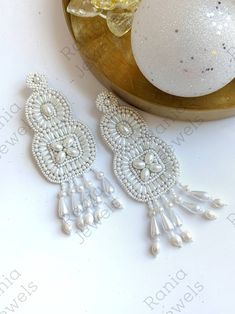 White color beaded earrings.  These earrings are very lightweight and easy to wear. Aa seen in editorials and on fashion influencers.  Hot selling! Earrings are completely handmade with Japanxese beads  Very light weight. Dimensions 4.52 inches long 1.63  inches wide (widest part) Elegant Summer Chandelier Earrings With Dangling Beads, Festive Beaded Dangle Pearl Earrings, Elegant Summer Beaded Earrings With Colorful Beads, Elegant Colorful Beaded Earrings For Summer, Elegant Summer Beaded Earrings With Dangling Beads, Elegant Summer Beaded Dangling Earrings, Elegant Chandelier Earrings With Colorful Beads For Summer, Elegant Summer Chandelier Earrings With Colorful Beads, Elegant Colorful Beaded Chandelier Earrings For Summer