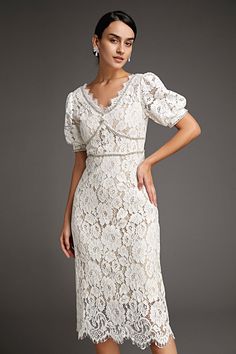 This lace crochet V-neckline midi dress will fill any of your little white dress needs, from your bridal shower to your after party. The textured lace overlay, accented with thick embroidery that outlines the lace’s blooms. Also features puff sleeves and delicate scalloped eyelash lace hem. The rhinestone trim and buttons adds an extra glitz and glam. No Stretch Medium Weight Size runs small,recommend one size up Fabric: 100% Polyester,Lining: 100% Polyester Model is 174cm/5'7" tall, 81cm/32" bust, 61cm/24" waist and 90cm/35" hip and wears a size S. Care Instruction: Hand Wash, Do not bleach, Dry flat in shade, Iron cool (max 110â„?, Dry clean, tetrachloroethylene(PCE) only.Please note: The images represent actual product though color of the image and product may slightly differ. This item Wedding Guest Dresses Formal, Midi Dress Wedding, Thick Embroidery, Modest Midi Dress, Vintage Dress Design, Dresses Wedding Guest, White Lace Shorts, Wedding Guest Dresses, Cap Dress