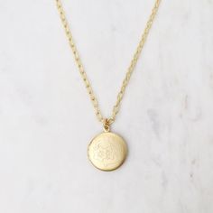 NKL-JM Round Floral Etched Locket Necklace Gold Heirloom Brass Locket Necklace, Heirloom Gold Brass Locket Necklace, Antique Gold Brass Medallion Necklace, Antique Gold Round Pendant Medallion Necklace, Heirloom Nickel-free Jewelry, Vintage Oval Jewelry With Coin Pendant, Antique Gold Vintage Charm Jewelry, Antique Gold Medallion Jewelry With Vintage Charm, Antique Medallion Necklace With Locket