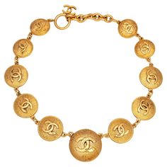 Vintage 80s Chanel medallion necklace crafted in yellow gold-tone (circa early 1980s). The necklace features 'CC' logo medallions that graduate in size from 22mm (0.86 inches) to 32mm (1.25 inches). Measuring 17 inches in length the necklace is slightly adjustable to 15 1/2 inches. The medallions are in very good condition (no chips or flaking). The necklace comes with the original Chanel box. The necklace is in very good condition showing minimal wear. Particulars: Weight: 90.8 grams Size & Measurements: The necklace measures 17 inches in length and is slightly adjustable to 15 1/2 inches. The medallions graduate in size from 22mm (0.86 inches) to 32mm (1.25 inches). Metal & Hallmark: Yellow gold tone. The necklace is hallmarked "Chanel", "Made in France", and "CC" and dates to the early Luxury Retro Gold Necklaces, Luxury Vintage Yellow Jewelry, 80s Chanel, Chanel Vintage Jewelry, Vintage Chanel Necklace, Men's Necklace Gold, Vintage Chanel Jewelry Dior, Chanel Medallion, Vintage Gold Necklace