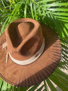 Each design is handcrafted with love in Mexico. Due to the nature of handmade items, no two pieces will be exactly the same. Sizes: M: Circumference is 58cm and fits most head sizes. L: Circumference is 62cm. Both sizes include an adjustable string inside for a secure fit. Rustic Adjustable Fedora With Flat Crown, Rustic Adjustable Brimmed Top Hat, Rustic Adjustable Brown Top Hat, Western Brown Boater Hat With Flat Crown, Adjustable Rustic Fedora Sun Hat, Artisan Fedora Panama Hat For Kentucky Derby, Brown Curved Brim Hat Bands For Kentucky Derby, Adjustable Rustic Fedora Hat, Rustic Adjustable Brimmed Hat