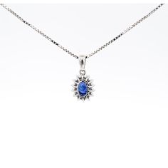 Item Details: - Type: Drop Pendant Necklace  - Metal: 18K White Gold  - Weight: 1.05 Grams (pendant only) - Setting: Prong, Halo ______________________________  Center Stone Details: - Type: Natural Sapphire  - Carat: 1.20  - Cut: Oval  - Color: Blue  - Measurements: 6.5 X 5 MM  ______________________________  Side Stone Details:  - Type: Natural Diamond  - Cut: Round  - Color: G-H - Clarity: SI1-SI2 - Quantity: 14  ______________________________  Dazzling modern drop pendant necklace, featuring a 1.20 carat natural oval cut Sapphire radiating a deep royal blue. This center stone is matched with 14 piece round-cut diamond halo in a star motif pendant made of 18K white gold. Set with an open back to allow for the center stone's natural color to be on full display.   The default order comes Oval Sapphire Necklace With Brilliant Cut, Blue Diamond Oval Pendant Jewelry, Oval Sapphire Necklace With Hallmark, Sapphire Oval Necklace With Diamond Cut, Oval Sapphire Necklace With Diamond Cut, Sapphire Diamond Oval Cabochon Jewelry, Sapphire Diamond Jewelry In Oval Cabochon Shape, Oval Sapphire Necklace With Halo Setting, Oval Sapphire Necklace With Polished Finish