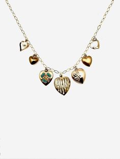 Nonnie Vintage/Antique Gold Filled Heart Charm Necklace It's no secret we are here for the multi-charm necklace trend! But this piece transcends time and trends, with seven unique vintage and antique heart charms affixed to a beautiful diamond-shaped 14K gold-filled chain. Detailed Description: Material: Gold Filled Design: Antique heart charms: pearl, gold-filled, puffy gold plated brass, heart with turquoise and seed pearls in the shape of a clover, encased crystal heart (brass), gilt gold victorian puffy heart, 1960s brass puffy heart, gold filled open heart with pearl Gemstones: pearls, turquoise Dimensions: 18" chain, but can be clasped shorter; center largest heart measures 3/4" Craftsmanship: Hand curated and assembled collection of vintage and antique hearts. Perfect For: A stateme Vintage Heart Charm Necklace, Yellow Gold Heart Necklace With Vintage Charm, Vintage Charm Necklace With Heart Charm For Anniversary, Vintage Yellow Gold Heart Charm Necklace, Vintage Yellow Gold Heart Necklace, Heirloom Necklace With Vintage Charm For Valentine's Day, Dainty Necklace With Vintage Heart Pendant, Dainty Necklace With Heart Pendant And Vintage Charm, Yellow Gold Necklaces With Removable Charms For Anniversary