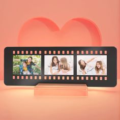 three pictures on a film strip with a heart in the background