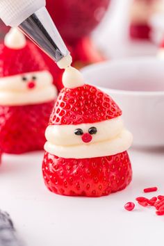 some strawberries with santa hats on them and the caption says, if you put a dot of frosting on the tips of each hat to create the pom pom