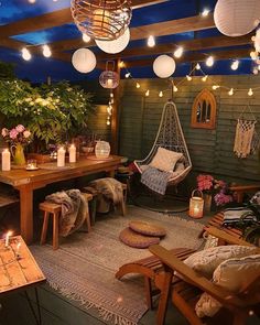 an outdoor room with hanging lights and furniture