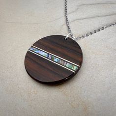 a wooden necklace with abangala inlays on it