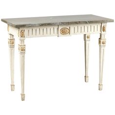 a white table with two drawers and gold accents on the top, against a white background