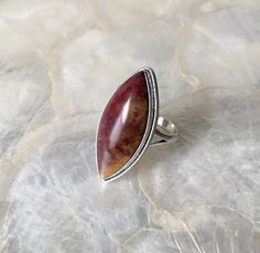 "This ring features a natural Red moss agate! The color can be described as a marbled red and yellow, creating something of an incapsulated flame. I'm more familiar with green Moss agate so I was excited to work with this! Immediately, I was drawn to this stone! The fibrous yellows and reds are contrasting yet complimenting, offering an intense and vibrant display of color! 🤤 I knew this babe was destined to be the ultimate statement ring! According to mossagategems.com some of the psychological benefits of Red Moss agate are that \"It enhances your sense of adventure and makes you free-spirited. It makes you active both physically and mentally and it makes you joyful and vibrant.\" They also mention that some of the emotional benefits include \"It makes you feel happy and positive about Unique Jasper Rings For Gift, Jasper Gemstone Rings Gift, Jasper Gemstone Rings For Gifts, Jasper Gemstone Rings As A Gift, Gift Jasper Gemstone Rings, Handmade Jasper Rings As Gift, Handmade Jasper Rings For Gift, Handmade Jasper Rings As A Gift, Healing Witch