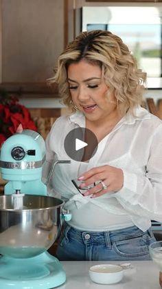 a woman mixing something in a bowl on top of a kitchen counter next to a mixer