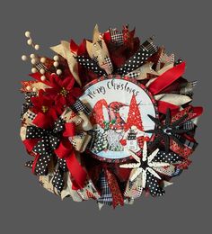 a christmas wreath with red, white and black decorations