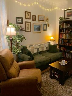 a living room with two couches and a coffee table in front of a bookshelf