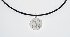 "This elegant necklace is sure to bring you many compliments ! I will carefully engrave a single, beautifully ornate script initial on this high polish 7/8\" diameter sterling silver disc. Take a look at the last picture - I have engraved a sample of each letter, so you can see what yours will look like! This lovely necklace is suitable for every day wear or formal events. The finished piece will be suspended on your choice of: *16\" rubber cord with stainless steel lobster clasp or *18\" rubber Elegant Round Pendant Necklace With Engraving Option, Elegant Round Disc Jewelry With Engraving Option, Elegant Pendant Necklaces With Engraving Option, Elegant Engraved Sterling Silver Initial Necklace, Elegant Adjustable Jewelry With Engraving Option, Formal Round Jewelry With Engraving Option, Formal Jewelry With Engraving Option, Classic Silver Round Disc Jewelry, Classic Round Pendant Initial Necklace For Anniversary