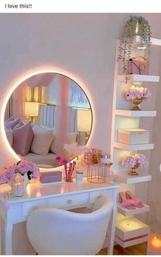 a white desk topped with a mirror next to a shelf filled with flowers and candles