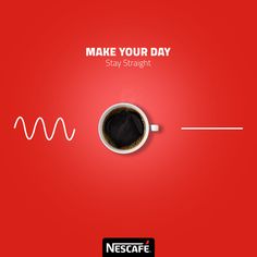 a cup of coffee sitting on top of a red table next to a sign that says make your day stay straight