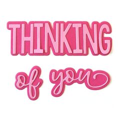 two pink stickers with the words thinking of you in different font styles and shapes