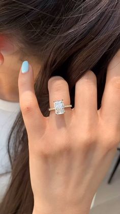 a woman's hand with a ring on her finger