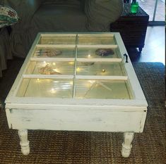 a coffee table made out of an old window pane with lights in the bottom