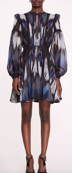 The Abstract Viscose Mini Dress is a chic and playful ensemble, featuring an a-line silhouette and a flattering v-neck design in abstract printed silk viscose. Its billowy sleeves and waist tie add a touch of femininity and versatility to the look, while delicate lace trims offer a hint of elegance. Billowy Sleeves, Lace Trims, Printed Silk, Waist Tie, Silk Printing, Blue Dresses