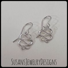 "These earrings are made with curved wire shaped into a neat squiggle design and hangs from ear hooks. Very lightweight and comfortable to wear. All components are sterling silver. Earring drop measures a little over 3/4\" from top of ear hook to bottom of squiggle area. Comes wrapped and ready to gift if needed. If you need more pairs of earrings than are available for purchase, please convo me before purchase and I help with additional quantities. To see my other earring items, click here: htt Modern Twist Dangle Earrings With Ear Wire, Modern Twist Dangle Jewelry With Matching Earrings, Modern Twist Jewelry With Matching Dangle Earrings, Modern Twist Silver Hypoallergenic Jewelry, Hypoallergenic Silver Jewelry With A Modern Twist, Modern Twist Hypoallergenic Silver Jewelry, Minimalist Spiral Jewelry With Matching Earrings, Wire Jewelry With Matching Earrings For Gift, Modern Twist Metal Earrings With Ear Wire