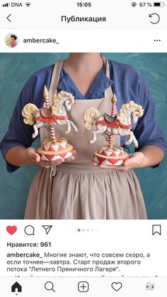 a woman holding two small figurines in her hands, both wearing aprons