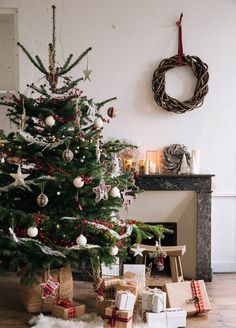 a decorated christmas tree with presents under it