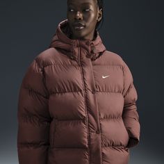 Up your outerwear game in this insulated puffer jacket. A loose fit makes it ideal for layering while the Nike Therma-FIT technology helps manage your body’s natural heat to help keep you warm in cold-weather conditions. A water-repellent finish, bungees at the hem and a hood work together to help shield you from wind and rain. Sporty Down Puffer Outerwear, Sporty Down Puffer Jacket With Detachable Hood, Sporty Nylon Puffer Parka, Sporty Puffer Jacket With Padded Collar For Cold Weather, Sporty Puffer Jacket With Adjustable Hood For Cold Weather, Sporty Down Outerwear With Detachable Hood, Sporty Puffer Outerwear For Outdoor Activities, Sporty Down Puffer Jacket With Adjustable Hood, Down Puffer Jacket With Double-lined Hood For Winter Sports