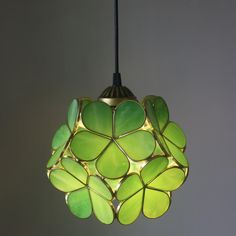 a green light fixture hanging from a ceiling