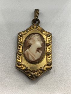 "A beautiful unique antique victorian cameo photo locket pendant made in with 12k gold filled in old good condition measures approx. 1 1/2\" x 3/4\" width." Cameo Medallion Locket Necklace, Vintage Cameo Pendant Locket Necklace, Antique Gold Cameo Medallion Locket Necklace, Victorian Gold Cameo Locket Necklace, Victorian Cameo Necklace For Memorial, Antique Cameo Medallion Locket Necklace, Victorian Cameo Locket Necklace For Formal Occasions, Antique Gold Cameo Locket Necklace, Gold Cameo Locket Necklace Collectible