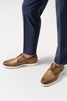 The Leone showcases Magnanni's take on a sophisticated dress hybrid. This dapper blucher features a traditional lace up design in supple calfskin leathers. The sleek dress silhouette is complemented with a comfortable and cushioned white rubber sole, making it the ideal selection for an on-the-go lifestyle. Timeless Leather Lace-up Shoes With Brogue Detailing, Modern Lace-up Leather Shoes For Derby, Calf Leather Lace-up Shoes For Derby With Textured Sole, Classic Lace-up Shoes In Calf Leather With Textured Sole, Classic Lace-up Shoes With Textured Sole In Calf Leather, Classic Low-top Lace-up Calf Leather Shoes, Calf Leather Lace-up Shoes For Derby, Calf Leather Lace-up Dress Shoes For Semi-formal, Low-top Calf Leather Lace-up Shoes For Derby