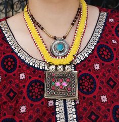 Unique Pashtun tribal Necklace Handmade by a group of women with fabric and vintage coins. Description: One of a kind Handmade ethnic necklace is attached to a fabric base using metallic beads.One large metallic tube bead is attached to metal hooks and beads,that are then connected to vintage amulet pendant,beautifully weaved in red glass beads. Button closure at the back. Free shipping in the US Vintage Coins, Group Of Women, Afghan Jewelry, Hand Carved Stone, Black Onyx Necklace, Ethnic Necklaces, Jewelry Bracelets Gold, Gold Bracelet Cuff, Coin Necklace