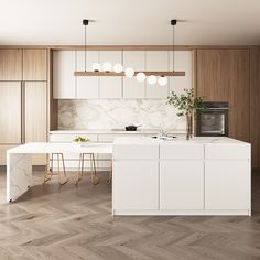 a modern kitchen with marble counter tops and white cabinets, along with wooden flooring