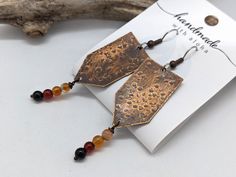 Handmade textured, lightweight copper boho style earrings with 4mm natural orange agate gemstones. Approx. 1.75 inch long, all on quality, surgical stainless steel ear wires. These quality handmade boho style earrings are created by JT Maui Designs. We've had excellent feedback with these stone and stainless pieces from those who often deal with allergies. Love the design, but need a favorite color or gemstone? Just message me as I stock approximately 12 colors in this size. GIFTING? Choose gift wrap for $1 at checkout if you'd like a fabric gift bag included. We are happy to send direct to your recipient if you are gifting it. Just be sure to update your ship to address within Etsy so your mailing label prints correctly. QUESTIONS: We are known for our quick response time, and creation ti Rust Dangle Earrings With Ear Wire, Rust Color Dangle Earrings With Ear Wire, Unique Rust Earrings With Ear Wire, Bohemian Rust Earrings With Ear Wire, Nickel Free Copper Orange Earrings, Adjustable Rust Earrings With Ear Wire, Hypoallergenic Brown Copper Earrings, Rustic Copper Earrings In Rust Color, Handmade Adjustable Rust Earrings