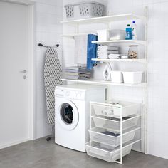 a washer and dryer in a room with white tile walls, flooring and shelving