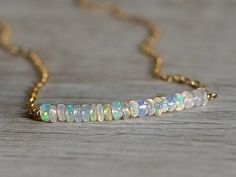 This beautifully hand made tiny Opal birthstone necklace is made using a sterling silver or a 14 carat gold plated chain with real Opal gemstones. Available on a 14 carat gold plated 45 cm necklace chain or solid sterling silver chain. Packaged in a gift box this necklace can be sent with a message directly to your gift recipient. The necklace chain is 40 - 60cm in length. Caring for your Opal jewellery - Opals are "hydrophane", which makes them thirsty for water. If the opals come in contact wi Dainty White Birthstone Necklaces, Dainty Jewelry With Adjustable Chain For Birthday, Dainty Adjustable Chain Jewelry For Birthday, Delicate White Birthstone Necklace, White Delicate Birthstone Necklace, Sterling Silver White Necklace For May Birthstone, White Sterling Silver Necklace For May Birthstone, Dainty White Birthstone Necklace For Anniversary, White Dainty Birthstone Necklace For Anniversary