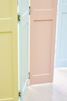 three different colored doors in an empty room