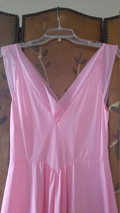 "70s gorgeous bubblegum pink nylon maxi slip / nightie by Vanity fair. The bust has delicate embroidered flower detail. Waist is accentuated with a deep V and a maxi length skirt part. Sheer hem and shoulder straps. **just very light 'scratch' marks on bottom of skirt but barely visible** Size 36 Nylon Length 55\", waist 28\" Made by vanity fair" V-neck Maxi Dress For Wedding Night In Spring, Summer Pink Maxi Dress With Lined Bodice, Pink Maxi Dress With Lined Bodice For Summer, Pink Lined Bodice Maxi Dress For Summer, Pink Maxi Dress With Sheer Bodice, Spring Pink Dress With Sheer Bodice, Pink Feminine Maxi Dress With Spaghetti Straps, Pink Sheer Maxi Dress For Summer, Feminine Pink Maxi Dress With Spaghetti Straps