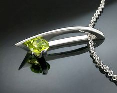 "Peridot Necklace - Argentium Silver - 3458 - Argentium Chain Included Modern and contemporary, this pendant makes a high fashion statement. ( IMPORTANT - PLEASE READ 1. AND 2 BELOW ) 1.) INCLUDED IN THE PRICE IS AN ARGENTIUM SILVER CHAIN APPROPRIATE FOR THE PENDANT CHOSEN. YOU CAN CHOOSE FROM 16\", 18\" OR 20\" LENGTH AT CHECKOUT. 2.) PLEASE LOOK AT THE MEASUREMENTS CAREFULLY. SOME PHOTOS HAVE BEEN ENLARGED TO SHOW DETAIL, WHILE OTHERS HAVE BEEN MINIMIZED TO FIT THE FRAME. ACTUAL SIZE CANNOT BE Modern Green Necklace With Polished Finish, Modern Peridot Jewelry As A Gift, Modern Peridot Jewelry For Gift, Modern Peridot Jewelry For Formal Occasions, Modern Silver Jewelry With Peridot, Modern Silver Peridot Jewelry, Contemporary Jewelry With Tension Setting As A Gift, Modern Green Peridot Jewelry, Modern Silver Jewelry For May Birthstone