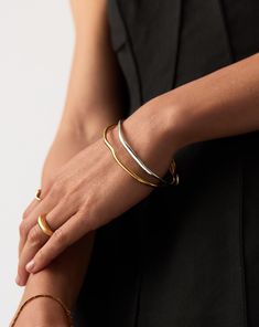 Molten Ripple Bangle Bracelet Set | Mixed Metal grey. Mix Your Metals with this Standout Bracelet Set. Paired Together, the Molten Ripple Bangles – in Gold and Silver – Feature an Organic-Inspired Shape with Our Signature Molten Wavy Detailing. Stack Together, Wear One on Each Wrist, or Wear Solo for Endless Ways to Style. Worth $448, Save $63 When Buying Together. Molten Ripple Bangle in Gold: Metal: 18K Recycled Gold Vermeil on Recycled Sterling Silver Molten Ripple Bangle in Silver: Metal: Rhodium Plated on Recycled Sterling Silver Small Band Width Varies from 2mm - 3. 8mm Inner Diameter: 60mm Weight: 23. 1g Medium Band Width Varies from 2mm - 3. 8mm Inner Diameter: 64mm Weight: 23. 4g Large Band Width Varies from 2mm - 3. 8mm Inner Diameter: 68mm Weight: 23. 4g Product Code: Set-B44 Mixing Metals Jewelry, Mixed Metals Jewelry Style, Small Band, Trending Bracelets, Mixed Metal Jewelry, Ring Trends, Bangle Bracelet Set, Earring Trends, Gold Signet Ring