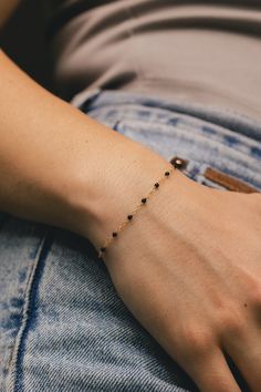 From our Color Romance Collection, this black enamel beaded piatto chain will add a pop of color to any outfit. Crafted in 14K gold, this 1 inch adjustable chain secures with a spring ring. NECKLACE DETAILS: Length: 7.5 Inches Millimeter: 1.7 Gauge: 030 Average Weight (g): 0.73 Closure: 5.0m Spring Ring Available in 14K Yellow Gold ***These necklaces have a 4 week lead time. If you need your necklace sooner than that, please contact us prior to ordering to verify if that's possible.*** | Black Enamel Bead Piatto Chain Bracelet In 14K Yellow Gold Ring - by Staghead Designs - Unisex Minimal Bangles Jewelry, 14k Gold Filled Beaded Chain Bracelets As Gift, Black Gold-plated Adjustable Chain Jewelry, Dainty Gold Beaded Bracelets, Black Jewelry With Delicate Round Chain, Black Jewelry With Delicate Chain, Elegant Yellow Gold Bracelets With Black Beads, Elegant Yellow Gold Bracelet With Black Beads, Trendy Black Chain Bracelet Gift