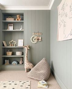 a baby's room with bookshelves and stuffed animals on the shelves, including a giraffe