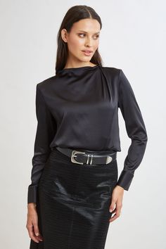 Chic & edgy, the draped neck of our luxe Silk Satin shirt creates a cool modern vibe that feels as good as it looks. The luxe patina, relaxed fit & soft neckline lend a feminine vibe to this must-have silk shirt. Elie Tahari Exclusive Long Sleeve Draped Neck Silk Shirt 93% Silk, 7% Elastane Runs true to Size Length From Shoulder to Hem: Back 23.25"L, Sleeve: 32.5"L (approx. length for size S) Model is 5'9" and wearing size XS Dry Clean Only Imported Style #: E9053534 Tahari Dress, Jumpsuit Jacket, Long Sleeve Short Dress, Satin Shirt, Elie Tahari, Modern Vibe, Knit Tees, Denim Coat, Knit Jacket