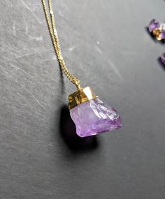 Raw amethyst is a classic in the world of gemstones. It is one of the more affordable stones with the most vibrant natural spectrum of purple tones. I have this necklace in both tiny crystals and large crystals, and a few different chain lengths 💟 **This listing is for only one necklace Each large crystal pendant measures approximately 1 inch in length.💜 Each small amethyst measures between 1/4 and 1/2 inch in length 💜 The chain for ThIs necklace measures 18 inches in length. You can purchase Gold Amethyst Crystal Necklace With Natural Stones, Amethyst Stone Necklaces For Gifts, Purple Amethyst Pendant Crystal Necklace, Purple Amethyst Necklace With Raw Stone, Amethyst Stone Necklace For Gift, Large Stone Mineral Crystal Necklaces For Jewelry Making, Purple Necklace With Large Stone For Gift, Lavender Amethyst Necklace With Stones, Large Stone Mineral Crystal Necklace For Jewelry Making