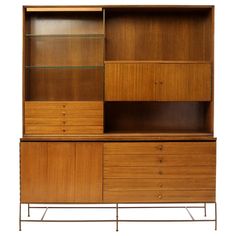 a wooden cabinet with glass shelves and drawers