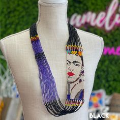 a white mannequin wearing a beaded necklace