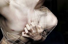 a man with his hands on his chest and lines drawn across the chest to form geometric shapes